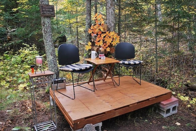 499 Tamarack Ct NE, Tenstrike, MN 56683 - wooden terrace featuring a forest view