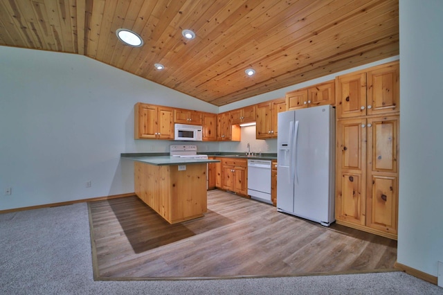 kitchen featuring white appliances, vaulted ceiling, recessed lighting, a peninsula, and baseboards