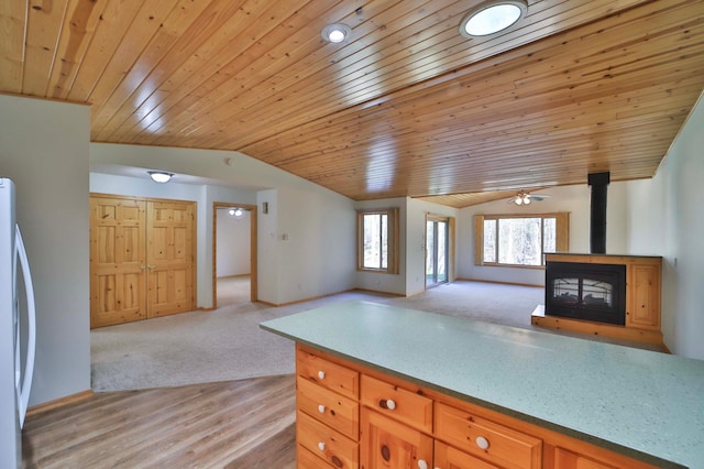 kitchen featuring open floor plan, vaulted ceiling, fridge, wood ceiling, and light carpet