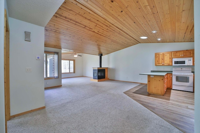 kitchen with white appliances, lofted ceiling, wood ceiling, light colored carpet, and baseboards