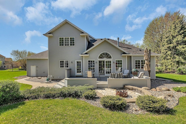 1609 26th St SE, Saint Cloud, MN 56304 - back of house with an outdoor fire pit, a deck, a yard, and french doors