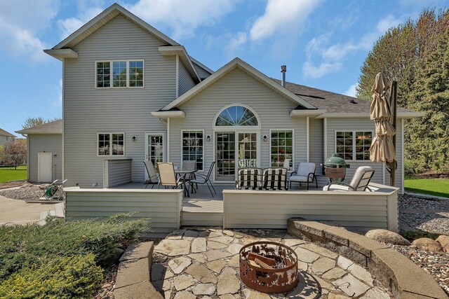 1609 26th St SE, Saint Cloud, MN 56304 - back of house featuring an outdoor fire pit, outdoor dining space, a patio area, and a wooden deck