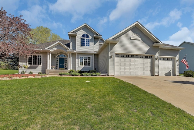 1609 26th St SE, Saint Cloud, MN 56304 - view of front facade featuring driveway, a garage, and a front lawn