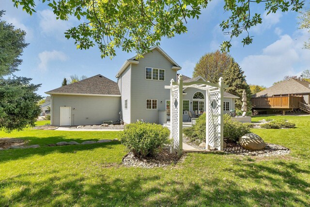 1609 26th St SE, Saint Cloud, MN 56304 - back of property with a lawn, a deck, and a shingled roof