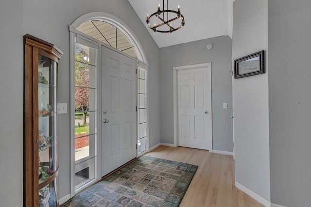 1609 26th St SE, Saint Cloud, MN 56304 - foyer featuring a chandelier, light wood-type flooring, baseboards, and high vaulted ceiling