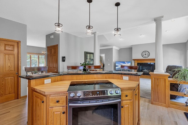 1609 26th St SE, Saint Cloud, MN 56304 - kitchen featuring ornate columns, electric range, and wood counters