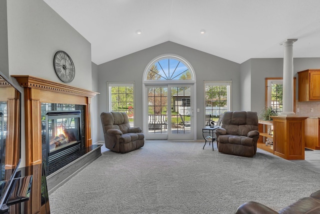 1609 26th St SE, Saint Cloud, MN 56304 - living area with decorative columns, vaulted ceiling, a glass covered fireplace, and carpet