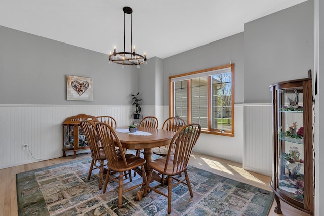 1609 26th St SE, Saint Cloud, MN 56304 - dining room featuring wainscoting, a chandelier, and wood finished floors