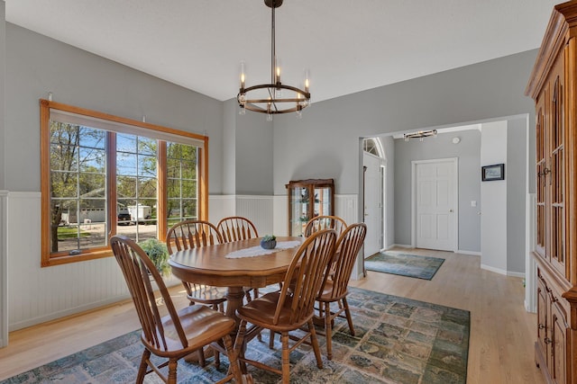 1609 26th St SE, Saint Cloud, MN 56304 - dining space featuring a chandelier, light wood-style floors, and a wainscoted wall