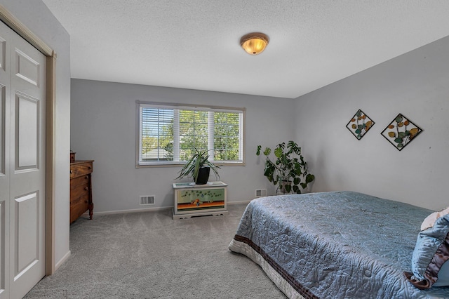 1609 26th St SE, Saint Cloud, MN 56304 - bedroom with carpet floors, baseboards, and a textured ceiling