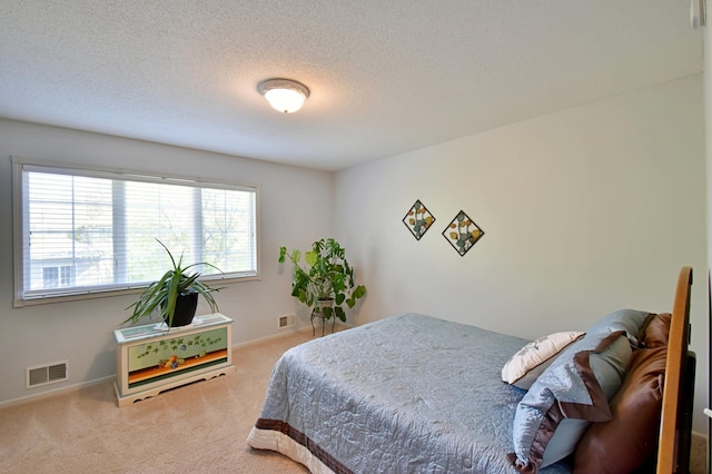 1609 26th St SE, Saint Cloud, MN 56304 - bedroom with carpet, a textured ceiling, and baseboards