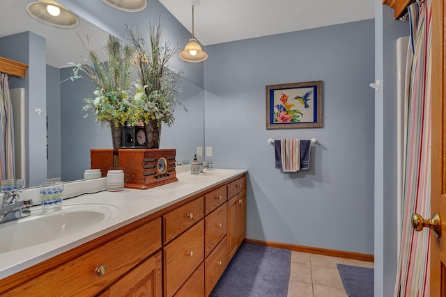 1609 26th St SE, Saint Cloud, MN 56304 - bathroom with double vanity, tile patterned flooring, and baseboards