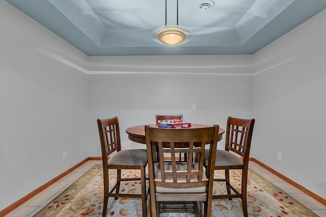 1609 26th St SE, Saint Cloud, MN 56304 - dining area with a tray ceiling, baseboards, and light tile patterned floors