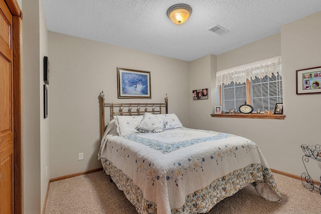 1609 26th St SE, Saint Cloud, MN 56304 - bedroom with carpet flooring, baseboards, and a textured ceiling