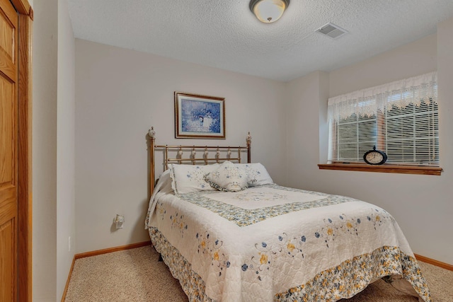 1609 26th St SE, Saint Cloud, MN 56304 - bedroom with carpet flooring, baseboards, and a textured ceiling