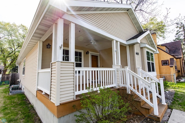 view of property exterior with a porch and fence