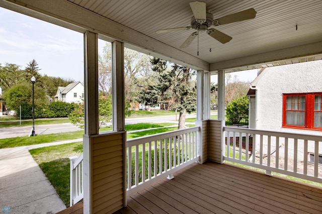 wooden deck featuring a porch and a ceiling fan