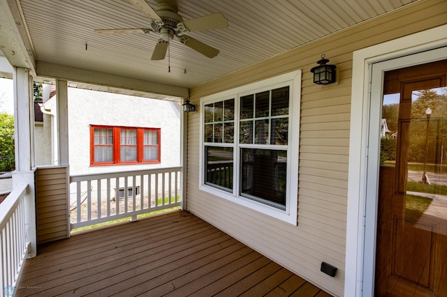 wooden deck featuring a ceiling fan and covered porch