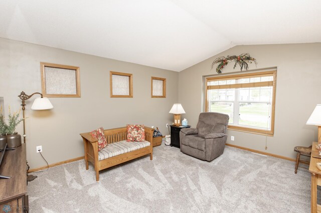 sitting room featuring baseboards, carpet, and lofted ceiling