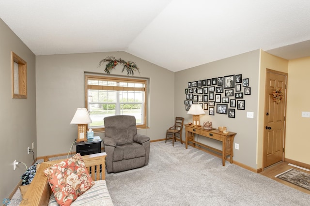 living room with baseboards, light carpet, and vaulted ceiling