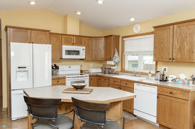 kitchen with white appliances, lofted ceiling, light countertops, and a sink