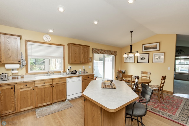 kitchen featuring white dishwasher, a sink, healthy amount of natural light, a kitchen island, and vaulted ceiling