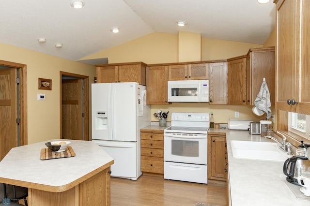 kitchen with white appliances, a sink, light countertops, vaulted ceiling, and a center island