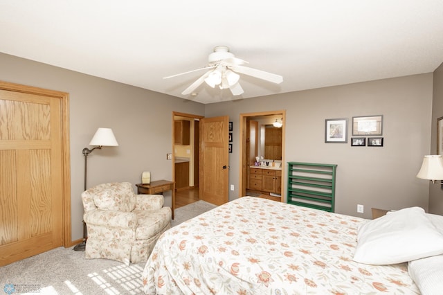 carpeted bedroom with baseboards, ceiling fan, and ensuite bath