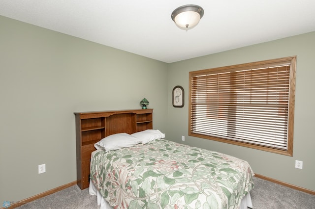 carpeted bedroom featuring baseboards