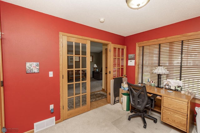 office space with french doors and carpet flooring