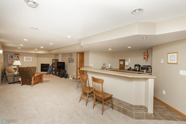 indoor wet bar featuring recessed lighting, light carpet, and baseboards
