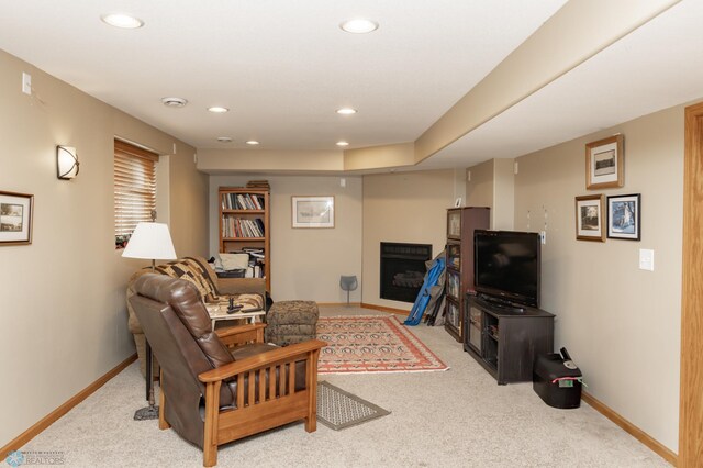 living room featuring baseboards, recessed lighting, and light colored carpet