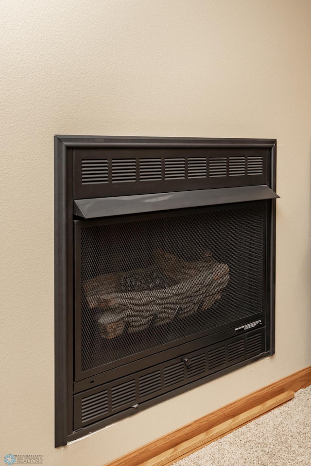 detailed view of carpet floors and baseboards
