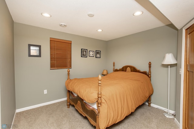 bedroom with light colored carpet, recessed lighting, and baseboards