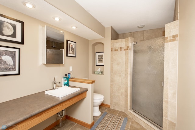 full bathroom featuring a sink, a stall shower, tile patterned flooring, toilet, and recessed lighting