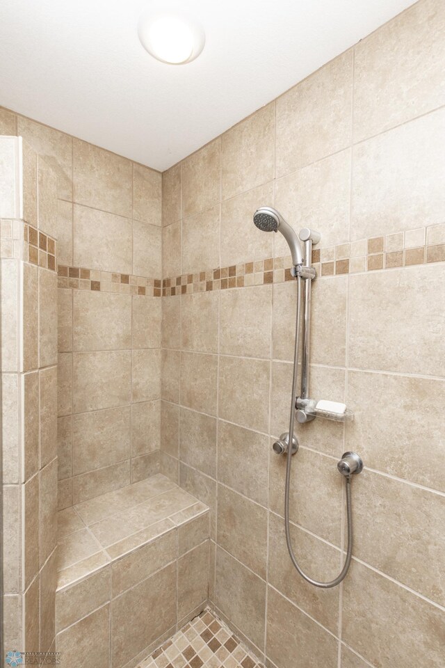 bathroom with tiled shower