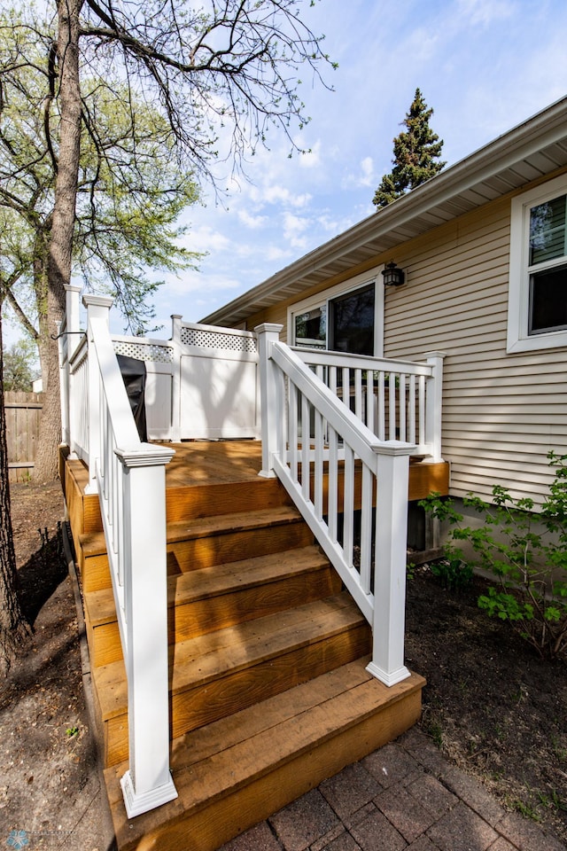 property entrance featuring a deck and fence