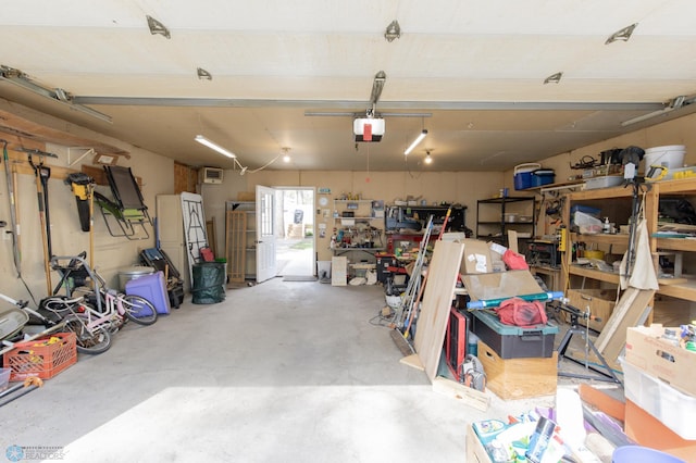 garage with a garage door opener and a workshop area
