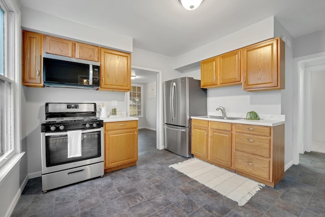 1925 Glenwood Ave, Minneapolis, MN 55405 - kitchen featuring appliances with stainless steel finishes, a sink, and baseboards