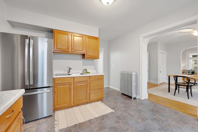 1925 Glenwood Ave, Minneapolis, MN 55405 - kitchen featuring radiator, freestanding refrigerator, a sink, and light countertops