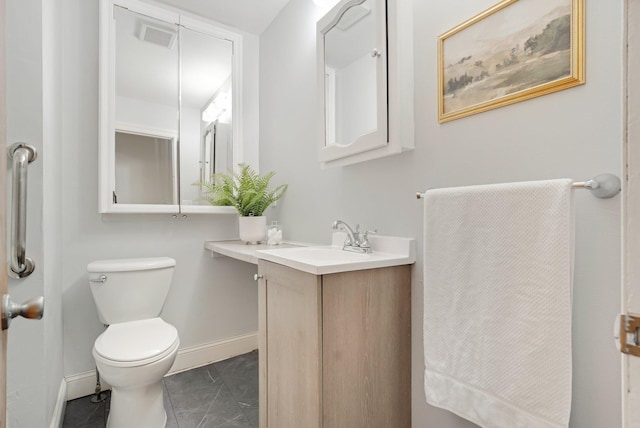1925 Glenwood Ave, Minneapolis, MN 55405 - bathroom featuring baseboards, toilet, and vanity