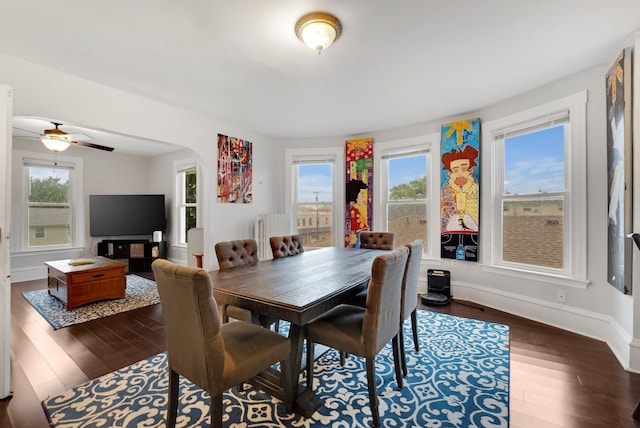 1925 Glenwood Ave, Minneapolis, MN 55405 - dining room with dark wood-style floors, arched walkways, baseboards, and ceiling fan