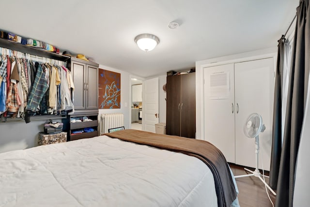 1925 Glenwood Ave, Minneapolis, MN 55405 - bedroom featuring radiator, wood finished floors, and a closet