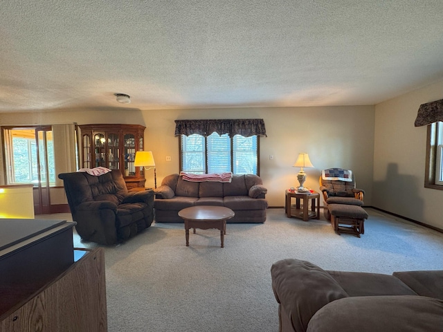 living room featuring carpet flooring and a textured ceiling