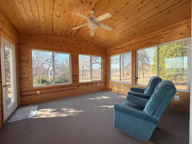 sunroom featuring wooden walls, lofted ceiling, carpet, and wooden ceiling