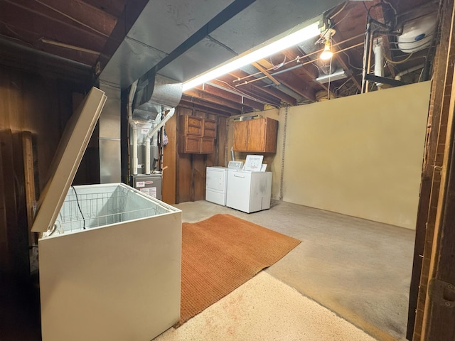 unfinished basement with washing machine and dryer and heating unit