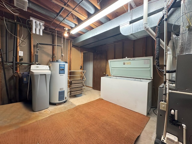 unfinished basement with electric water heater and a water softener system