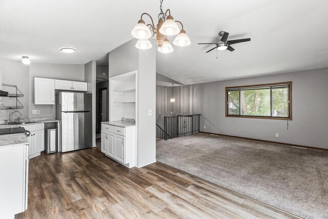 1260 Ferndale St N, Maplewood, MN 55119 - kitchen featuring freestanding refrigerator, lofted ceiling, a sink, white cabinets, and open shelves