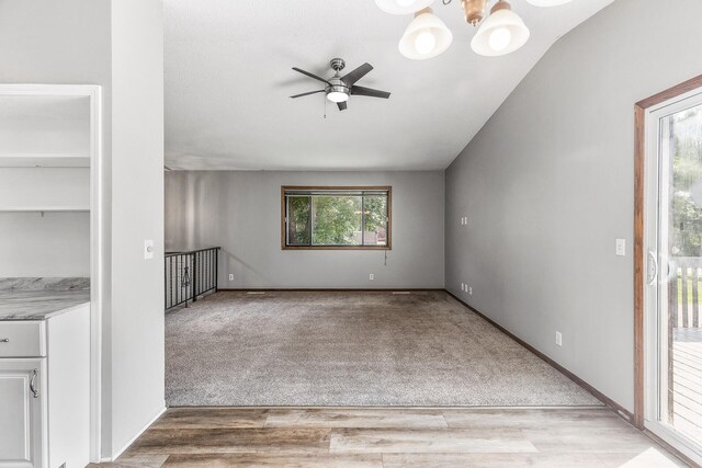 1260 Ferndale St N, Maplewood, MN 55119 - spare room with ceiling fan, light wood-style flooring, light carpet, and a chandelier