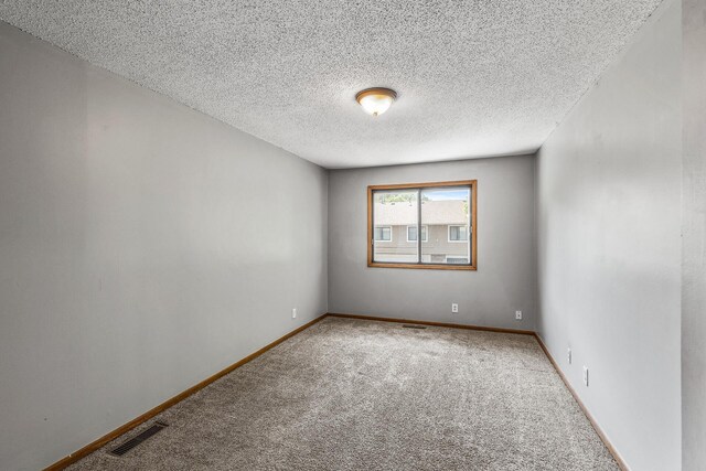 1260 Ferndale St N, Maplewood, MN 55119 - carpeted empty room featuring a textured ceiling and baseboards